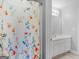Bathroom showcases a white floral shower curtain complementing the white vanity at 4147 Alayna Lee Cir, Mcdonough, GA 30252