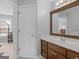 Bathroom with dark wood vanity, white countertop and framed mirror with decorative details at 4147 Alayna Lee Cir, Mcdonough, GA 30252