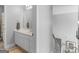 Bathroom featuring a single sink vanity and neutral decor, easily accessible and conveniently located near the stairs at 4147 Alayna Lee Cir, Mcdonough, GA 30252