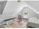 Attic bedroom features a metal bed frame and a unique rug at 4147 Alayna Lee Cir, Mcdonough, GA 30252