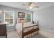 Charming bedroom with a wooden frame bed, two windows, and a ceiling fan at 4147 Alayna Lee Cir, Mcdonough, GA 30252