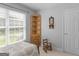Bedroom with white walls, hardwood corner shelving unit, and a decorative wooden chair at 4147 Alayna Lee Cir, Mcdonough, GA 30252