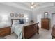 Inviting bedroom with a comfortable bed, wooden nightstand, and warm lighting offering a serene ambiance at 4147 Alayna Lee Cir, Mcdonough, GA 30252
