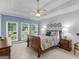 Bright bedroom with a ceiling fan, large windows, and a comfortable bed, creating a relaxing retreat at 4147 Alayna Lee Cir, Mcdonough, GA 30252