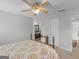 Bright bedroom featuring a wooden frame bed and access to a well-lit bathroom at 4147 Alayna Lee Cir, Mcdonough, GA 30252