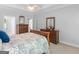Spacious bedroom featuring a comfortable bed, wooden dressers, and neutral walls with ample natural light at 4147 Alayna Lee Cir, Mcdonough, GA 30252