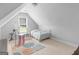 Cozy attic bedroom with a metal bed frame and natural light from the window at 4147 Alayna Lee Cir, Mcdonough, GA 30252