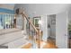 Open hallway with a staircase, hardwood floors, and a view into a powder room, enhancing the home's appeal at 4147 Alayna Lee Cir, Mcdonough, GA 30252