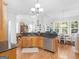 Open kitchen features granite countertops, wooden cabinets, and stainless-steel appliances at 4147 Alayna Lee Cir, Mcdonough, GA 30252