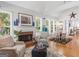 Bright living room with brick fireplace, hardwood floors, and large windows at 4147 Alayna Lee Cir, Mcdonough, GA 30252