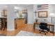 Bright office space adjacent to kitchen with hardwood floors and natural light at 4147 Alayna Lee Cir, Mcdonough, GA 30252