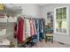 Bright walk-in closet with wire shelving, clothing racks, and a window for natural light at 4147 Alayna Lee Cir, Mcdonough, GA 30252