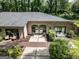 Aerial view showcases a brick exterior, lush landscaping, outdoor seating, and well-maintained backyard at 4187 Cherry Laurel Se Dr, Covington, GA 30014