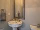 Elegant half bathroom with a pedestal sink, ornate mirror, and decorative accents at 4187 Cherry Laurel Se Dr, Covington, GA 30014