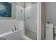 An elegant bathroom featuring a walk-in shower and a soaking tub with modern faucets at 4187 Cherry Laurel Se Dr, Covington, GA 30014