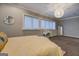 Bedroom featuring a decorative ceiling light, a large bed, and a desk near windows at 4187 Cherry Laurel Se Dr, Covington, GA 30014