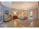 Spacious main bedroom with a luxurious bed, chandelier, and a door to the outside at 4187 Cherry Laurel Se Dr, Covington, GA 30014