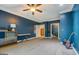 Bedroom featuring blue walls, a ceiling fan, carpet, and multiple doorways in the house at 4187 Cherry Laurel Se Dr, Covington, GA 30014