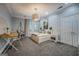 A spacious bedroom features natural light, hanging chair, work desk, and neutral color palette at 4187 Cherry Laurel Se Dr, Covington, GA 30014