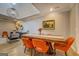 Contemporary dining room with wooden table, bright orange chairs, and modern decor with statement lighting at 4187 Cherry Laurel Se Dr, Covington, GA 30014