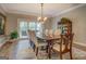 Formal dining room featuring a wood table, decorative chandelier, rug, and glass cabinet for elegant dining experiences at 4187 Cherry Laurel Se Dr, Covington, GA 30014
