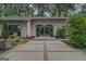 Elegant brick exterior with arched double doors and modern concrete pavers leading to the inviting entrance at 4187 Cherry Laurel Se Dr, Covington, GA 30014