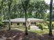 Attractive brick home with landscaped front yard, featuring a pathway and mature trees offering privacy at 4187 Cherry Laurel Se Dr, Covington, GA 30014
