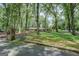 A circular home is surrounded by lush greenery and tall trees and is placed far from the street at 4187 Cherry Laurel Se Dr, Covington, GA 30014