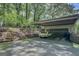 Attached garage with parking space and classic car, featuring a convenient carport and lush surroundings at 4187 Cherry Laurel Se Dr, Covington, GA 30014