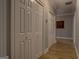 Hallway with multiple closets featuring wood-look flooring and modern lighting at 4187 Cherry Laurel Se Dr, Covington, GA 30014