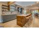 Gourmet kitchen with a large island, breakfast bar, stainless steel appliances, and modern backsplash at 4187 Cherry Laurel Se Dr, Covington, GA 30014