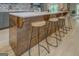 Kitchen island with seating, showcasing wood accents, white countertops, and modern barstools at 4187 Cherry Laurel Se Dr, Covington, GA 30014