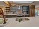 Stylish kitchen featuring a large island with a stainless steel sink, modern cabinets, and open layout at 4187 Cherry Laurel Se Dr, Covington, GA 30014