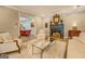 A bright living room area with fireplace, decorated with large ornate mirror and painting at 4187 Cherry Laurel Se Dr, Covington, GA 30014