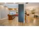 Open-concept living space featuring wood floors, a modern kitchen island, and a cozy living room with a fireplace at 4187 Cherry Laurel Se Dr, Covington, GA 30014