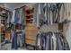 Walk-in closet features custom shelving and clothes racks for maximum storage at 4187 Cherry Laurel Se Dr, Covington, GA 30014
