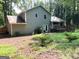 Exterior view of the home's backyard with a deck and mature landscaping at 7813 Sugarland Dr, Jonesboro, GA 30236