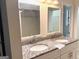 Bathroom vanity with granite countertop, double sinks, and large mirrors at 7813 Sugarland Dr, Jonesboro, GA 30236