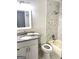 Bathroom features marble-like tiled walls, shower-tub combo and granite countertop vanity at 7813 Sugarland Dr, Jonesboro, GA 30236