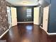 Bedroom with hardwood floors, fresh paint, and ample closet space at 7813 Sugarland Dr, Jonesboro, GA 30236