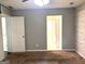 Bedroom features carpet, neutral colored walls, a window and stylish brick accent wall at 7813 Sugarland Dr, Jonesboro, GA 30236