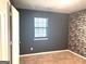 Bedroom features neutral carpet, textured wall, and a window for natural light at 7813 Sugarland Dr, Jonesboro, GA 30236