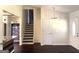 Bright entryway featuring hardwood floors, a staircase, and a view into another room at 7813 Sugarland Dr, Jonesboro, GA 30236