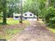 Traditional style home featuring a two-car garage and a spacious front yard at 7813 Sugarland Dr, Jonesboro, GA 30236