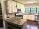 Renovated kitchen with granite countertops and modern stainless steel appliances at 7813 Sugarland Dr, Jonesboro, GA 30236