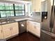 Bright kitchen features wood floor, granite countertops, stainless steel refrigerator, and a large window at 7813 Sugarland Dr, Jonesboro, GA 30236