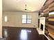 Bright living room with hardwood floors, a ceiling fan, and a fireplace at 7813 Sugarland Dr, Jonesboro, GA 30236