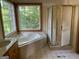 Bathroom featuring a large soaking tub, a glass-enclosed shower, and tiled flooring at 823 Mountain View Run, Stone Mountain, GA 30087