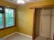Bedroom with a window offering ample natural light and a closet with bi-fold doors at 823 Mountain View Run, Stone Mountain, GA 30087
