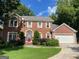 Charming brick home with a well-manicured lawn, mature trees, and a two-car garage at 823 Mountain View Run, Stone Mountain, GA 30087